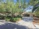 Charming single-story home featuring a long driveway and lush landscaping, including mature trees offering shade at 4711 W Vasconia St, Tampa, FL 33629
