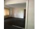 A bright living room area with white walls and dark flooring at 4711 W Vasconia St, Tampa, FL 33629