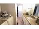 Bright bathroom with granite countertops, wooden floors, and updated fixtures at 4851 W Gandy Blvd # 23C, Tampa, FL 33611