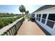 Enjoy beautiful water views from this lovely wooden deck, with green railing and a place to grill at 4851 W Gandy Blvd # 23C, Tampa, FL 33611