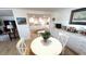 The dining area has a table, chairs, and updated flooring at 4851 W Gandy Blvd # 23C, Tampa, FL 33611