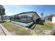 Charming home showcasing a well-maintained exterior and wooden deck, enhanced by a lush lawn in a serene neighborhood at 4851 W Gandy Blvd # 23C, Tampa, FL 33611