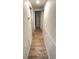 Hallway with wood-look flooring and white wainscoting at 4851 W Gandy Blvd # 23C, Tampa, FL 33611