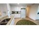 Bright kitchen with white cabinets, granite countertops, stainless steel sink and modern appliances at 4851 W Gandy Blvd # 23C, Tampa, FL 33611
