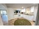 Bright, updated kitchen with granite counters, white cabinets, and modern appliances at 4851 W Gandy Blvd # 23C, Tampa, FL 33611