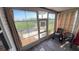 Relaxing screened porch with tile floors, neutral drapes and lovely water views from this comfortable seating area at 4851 W Gandy Blvd # 23C, Tampa, FL 33611
