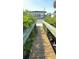 Wood boardwalk surrounded by lush greenery and leading to the property entrance of this waterfront home at 4851 W Gandy Blvd # 23C, Tampa, FL 33611