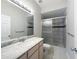 Bathroom featuring tiled shower with glass door and marble-look vanity countertop at 5048 Sunridge Palms Dr # 103, Tampa, FL 33617