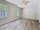 Bright bedroom featuring modern vinyl floors, neutral walls, and natural light at 5048 Sunridge Palms Dr # 103, Tampa, FL 33617