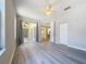 Spacious bedroom featuring light-colored walls, ceiling fan, and sliding doors to the outdoors at 5048 Sunridge Palms Dr # 103, Tampa, FL 33617
