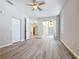 Open bedroom with vinyl flooring, white doors, and access to the outdoor patio at 5048 Sunridge Palms Dr # 103, Tampa, FL 33617