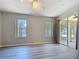 Inviting bedroom with vinyl flooring, dual windows, and a sliding glass door to the patio at 5048 Sunridge Palms Dr # 103, Tampa, FL 33617