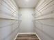 Walk-in closet with white wire shelving and wood-look flooring at 5048 Sunridge Palms Dr # 103, Tampa, FL 33617
