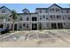 Three-story condominium building with parking; gray tone with painted white trim at 5048 Sunridge Palms Dr # 103, Tampa, FL 33617
