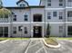 Three-story condominium building with parking; gray tone with painted white trim at 5048 Sunridge Palms Dr # 103, Tampa, FL 33617