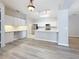 Modern kitchen with white cabinets, quartz countertops, and stainless steel appliances at 5048 Sunridge Palms Dr # 103, Tampa, FL 33617