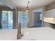 Open floor plan featuring quartz countertops, stainless steel faucet, and sliding glass doors at 5048 Sunridge Palms Dr # 103, Tampa, FL 33617
