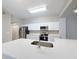 Modern kitchen featuring white cabinets, quartz countertops, and stainless steel appliances at 5048 Sunridge Palms Dr # 103, Tampa, FL 33617