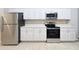 Updated kitchen featuring stainless steel appliances, white cabinets, and tiled flooring at 5048 Sunridge Palms Dr # 103, Tampa, FL 33617