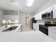 Bright kitchen featuring white cabinets, stainless steel appliances, and quartz countertops at 5048 Sunridge Palms Dr # 103, Tampa, FL 33617