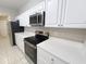 Modern kitchen with stainless steel appliances, quartz countertops, and ample cabinet space at 5048 Sunridge Palms Dr # 103, Tampa, FL 33617