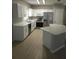 Modern kitchen featuring stainless steel appliances, white cabinetry, and an island at 5101 Corvette Dr, Tampa, FL 33624