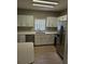 Well-lit kitchen with white cabinets, stainless steel appliances and ample counter space at 5101 Corvette Dr, Tampa, FL 33624