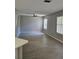 Spacious living room featuring wood-look floors and natural light through window blinds at 5101 Corvette Dr, Tampa, FL 33624