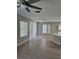 Bright living room area with wood look flooring, ceiling fan, and ample natural light at 5101 Corvette Dr, Tampa, FL 33624