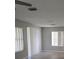Spacious living room with neutral paint and lots of light from the sliding glass doors and large windows at 5101 Corvette Dr, Tampa, FL 33624