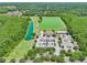 An aerial view shows the Lexington Oaks Golf Club, a lake, parking, and the surrounding green space at 5340 Riva Ridge Dr, Wesley Chapel, FL 33544