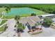 Aerial view of the Lexington Oaks Golf Club with a lake, landscaping, and golf cart parking at 5340 Riva Ridge Dr, Wesley Chapel, FL 33544
