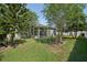 Spacious backyard with lush green grass and an enclosed sunroom attached to the house at 5340 Riva Ridge Dr, Wesley Chapel, FL 33544