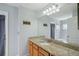 Bathroom featuring a granite countertop and a spacious mirror over a wood vanity cabinet at 5340 Riva Ridge Dr, Wesley Chapel, FL 33544