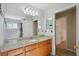 Bathroom featuring a granite countertop and a spacious mirror over a wood vanity cabinet at 5340 Riva Ridge Dr, Wesley Chapel, FL 33544