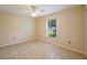 This bedroom includes tile flooring and a ceiling fan for added comfort at 5340 Riva Ridge Dr, Wesley Chapel, FL 33544