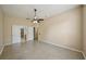Large bedroom with a ceiling fan, tiled floors, and an ensuite bathroom at 5340 Riva Ridge Dr, Wesley Chapel, FL 33544