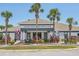 Front view of Lexington Oaks Golf Club featuring manicured landscaping, columns, and exterior architecture at 5340 Riva Ridge Dr, Wesley Chapel, FL 33544