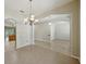 Bright dining room with a large arched window and decorative chandelier at 5340 Riva Ridge Dr, Wesley Chapel, FL 33544