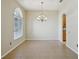 Bright dining room with a large arched window, chandelier and wood flooring at 5340 Riva Ridge Dr, Wesley Chapel, FL 33544