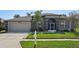 Charming single Gathering home with a well-maintained lawn, a two-car garage and inviting curb appeal at 5340 Riva Ridge Dr, Wesley Chapel, FL 33544