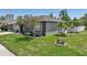 Charming single-story home with well-maintained landscaping and a lovely blooming tree in the front yard at 5340 Riva Ridge Dr, Wesley Chapel, FL 33544