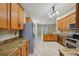 Open kitchen boasts wooden cabinets, stainless steel appliances, and granite countertops at 5340 Riva Ridge Dr, Wesley Chapel, FL 33544