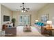 This staged living room features modern furnishings and glass doors leading to the outdoors at 5340 Riva Ridge Dr, Wesley Chapel, FL 33544