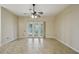 Open-concept living area with sliding glass doors and ceiling fan at 5340 Riva Ridge Dr, Wesley Chapel, FL 33544