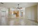 Open-concept living area with neutral walls, ceramic tile floors and a view of the kitchen area at 5340 Riva Ridge Dr, Wesley Chapel, FL 33544