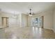 Open-concept living area with sliding glass doors and tile floors at 5340 Riva Ridge Dr, Wesley Chapel, FL 33544