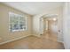 Bright room with a large window, tiled floor and an arched entryway at 5340 Riva Ridge Dr, Wesley Chapel, FL 33544
