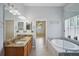 Beautiful main bathroom with granite countertops, dual sinks, soaking tub and glass shower at 5340 Riva Ridge Dr, Wesley Chapel, FL 33544