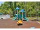 Brightly colored play equipment with slides and spring riders in the community playground at 5340 Riva Ridge Dr, Wesley Chapel, FL 33544